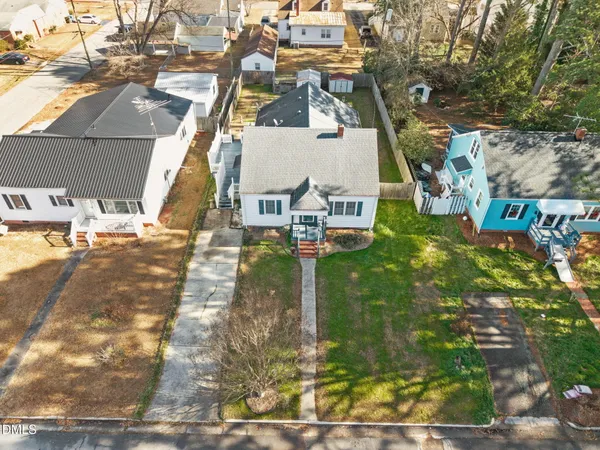 an aerial view of a residential apartment building with a yard