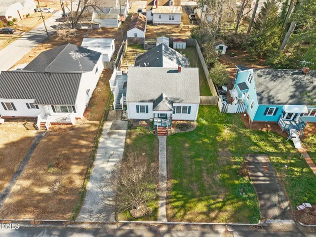 an aerial view of a residential apartment building with a yard