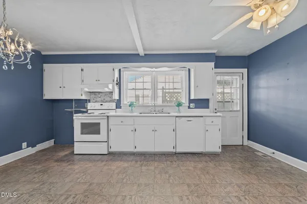 a view of a kitchen with a sink and cabinet