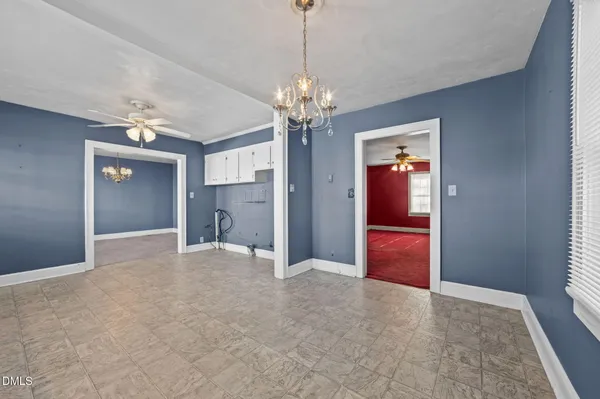a kitchen with cabinets appliances a sink and a window