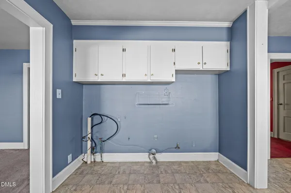 a view of a hallway with a chandelier fan and windows