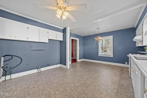 a large white kitchen with a window