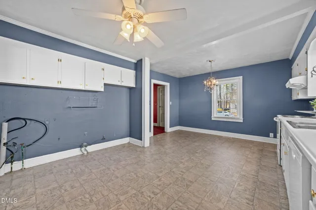 a large white kitchen with a window
