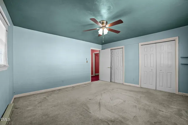 a view of a livingroom with a ceiling fan and window