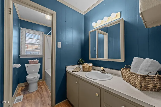 a view of an empty room and window and chandelier fan
