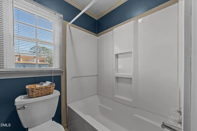 a bathroom with a sink toilet and mirror