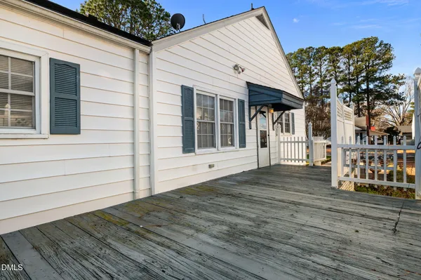 a view of house with wooden floor and large trees