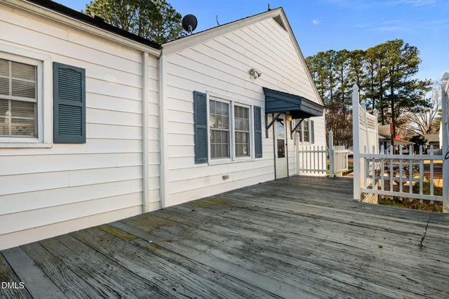 a view of house with wooden floor and large trees