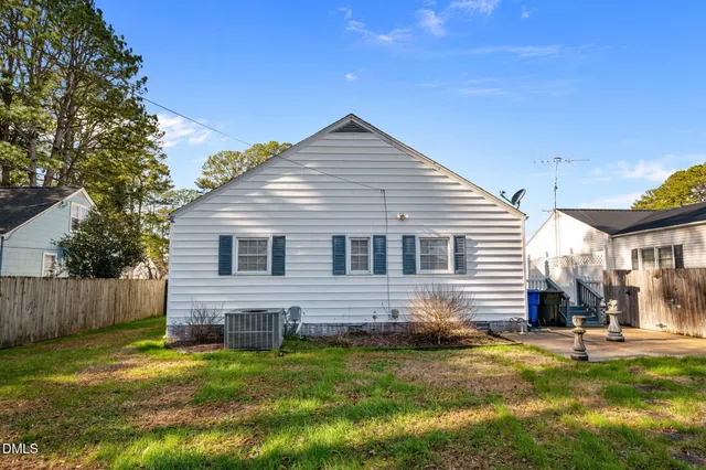 a view of a house with a yard and sitting area