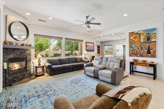 a living room with furniture a flat screen tv and a fireplace