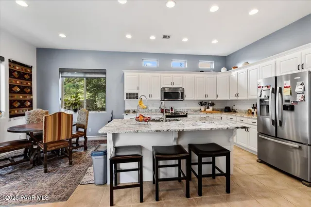 a kitchen with microwave a stove and cabinets