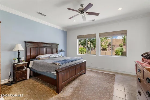 a bedroom with a large bed and a bookshelf