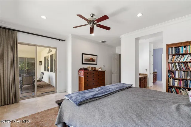 a en suite bathroom with a granite countertop sink and a mirror