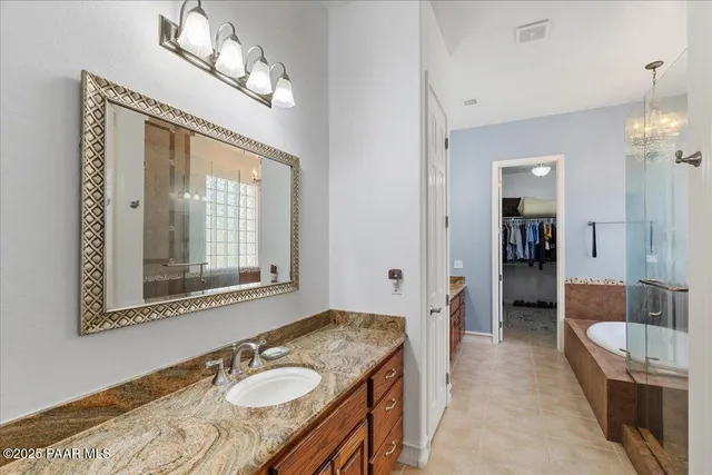 a bathroom with a tub a sink and a shower