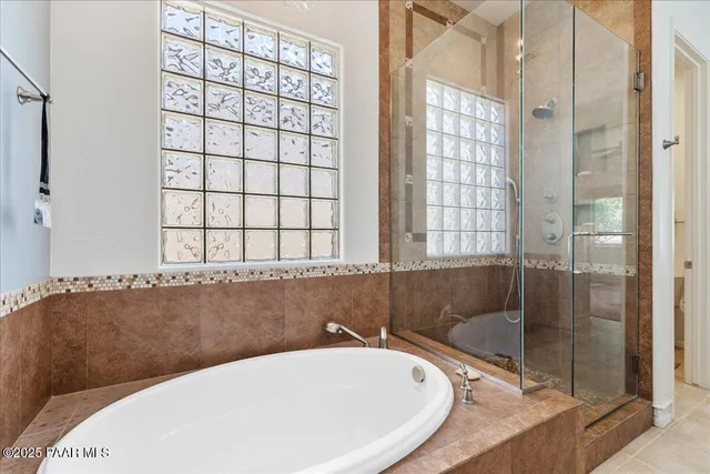 a walk in closet with clothes and shoes