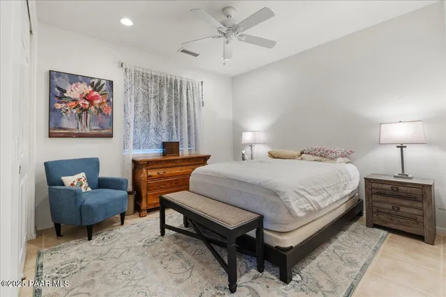 a bathroom with a granite countertop sink a toilet a mirror and shower