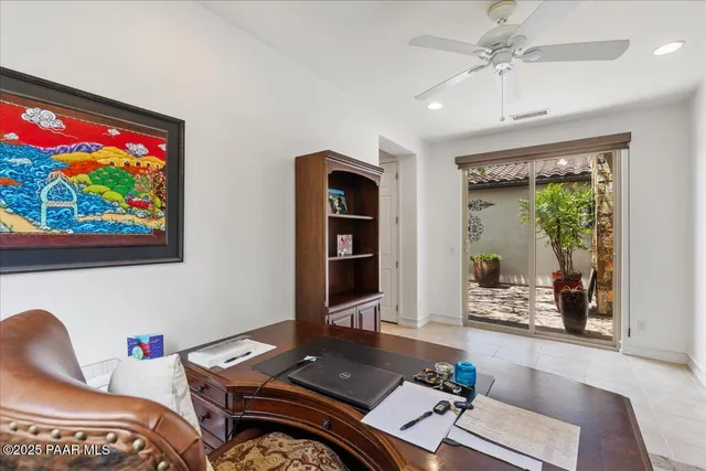 a view of a workspace with furniture and a gate