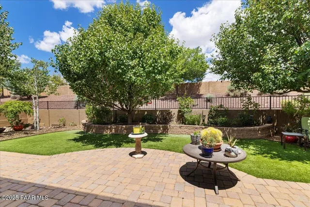 a view of a backyard with sitting area and garden