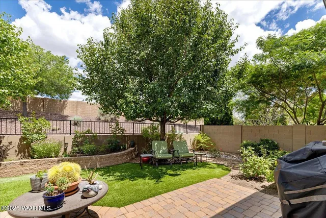 a view of a backyard with furniture and a fire pit