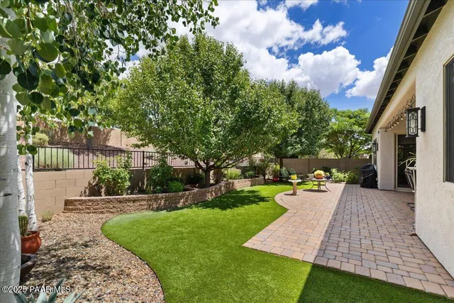 a view of a house with backyard porch and sitting area