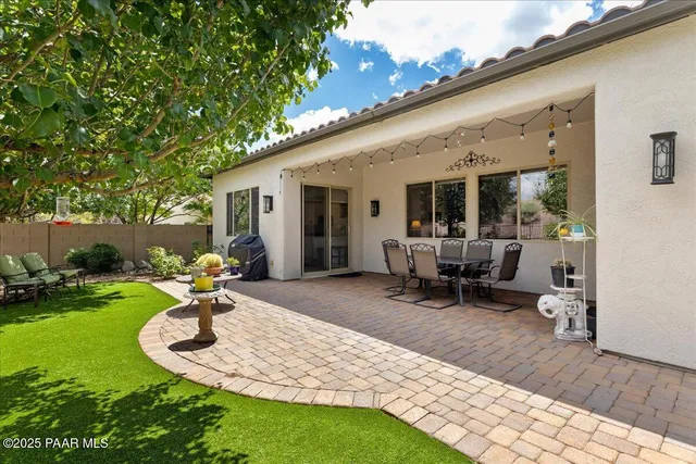 a view of a backyard with plants and patio