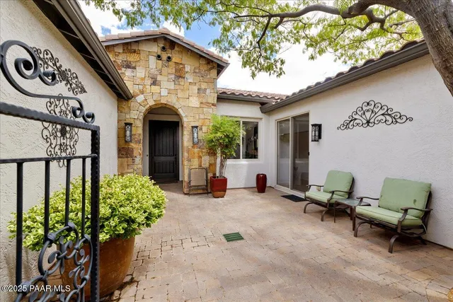 a backyard of a house with outdoor seating