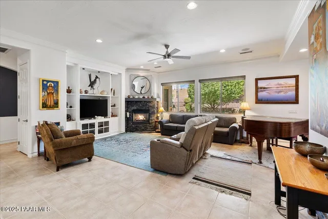 a living room with furniture a fireplace and a flat screen tv
