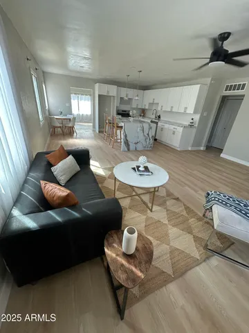 an empty room with windows and ceiling fan