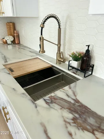 a kitchen with cabinets a sink and appliances
