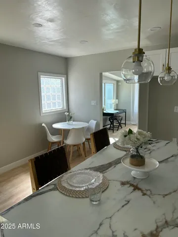 a living room with furniture and a dining table