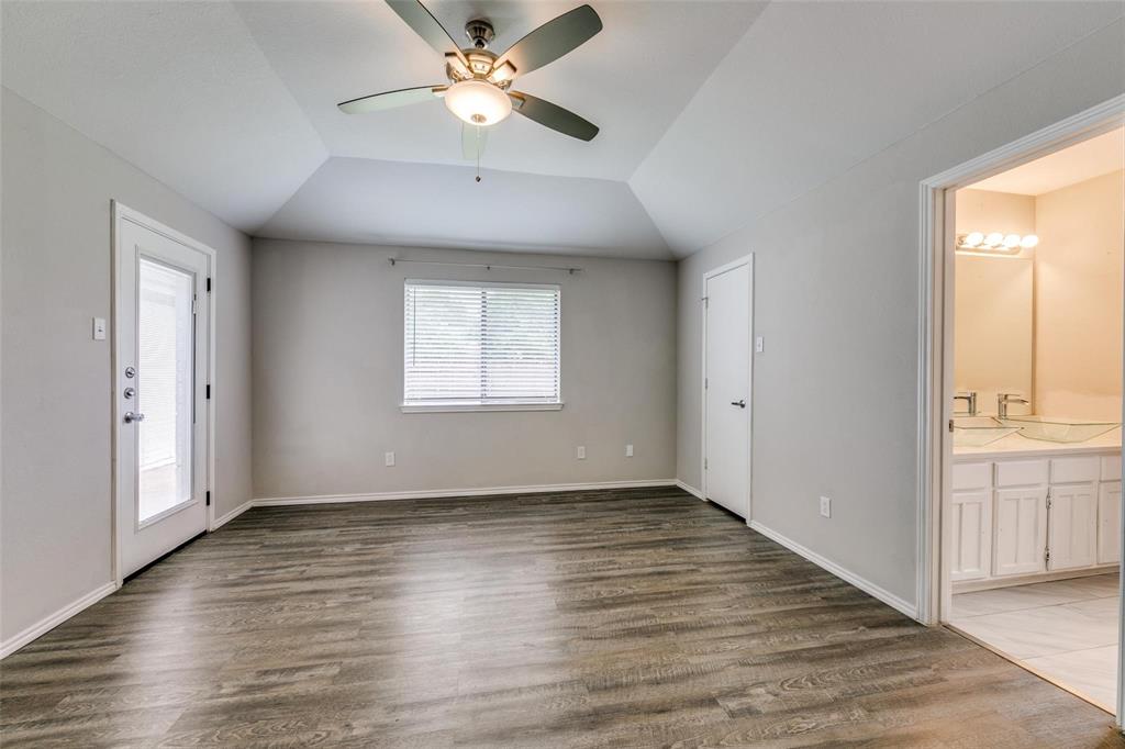 701 Kipling Drive Plano, TX 75023 - Photo 17 of 24 an empty room with wooden floor fan and windows
