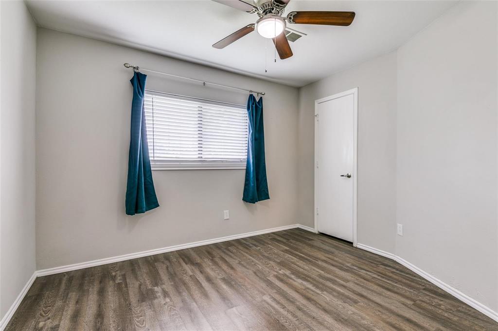 701 Kipling Drive Plano, TX 75023 - Photo 21 of 24 an empty room with wooden floor and windows