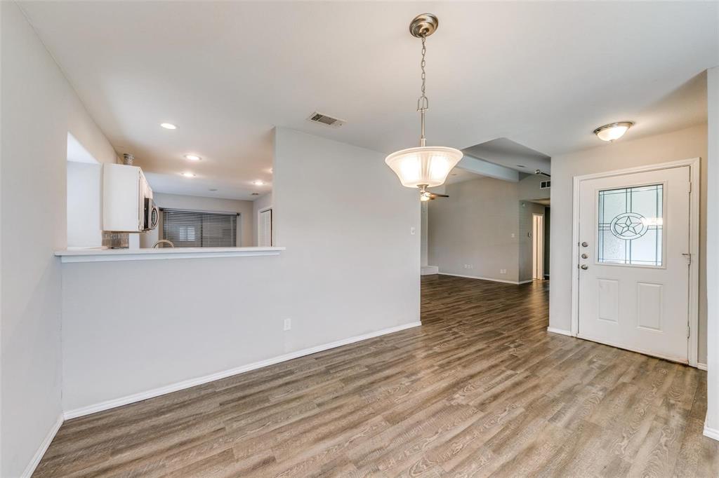 701 Kipling Drive Plano, TX 75023 - Photo 3 of 24 a view of a room with wooden floor and a ceiling fan