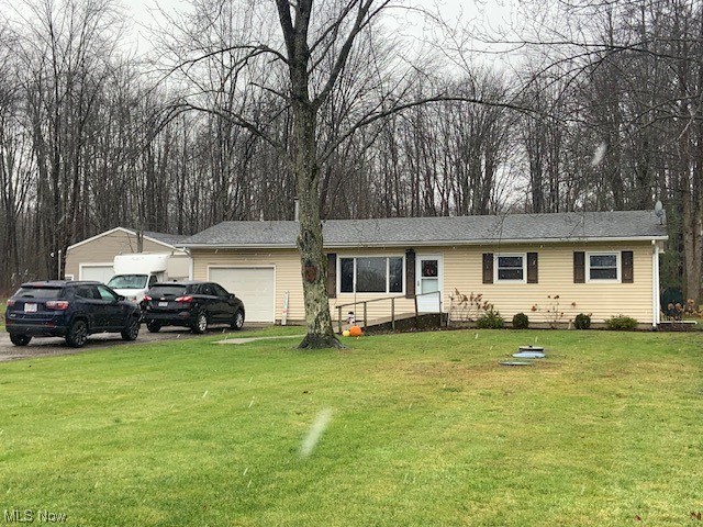 4713 Highway 534 Rome, OH 44085 - Photo 1 of 21 Ranch-style home with a front yard and a garage