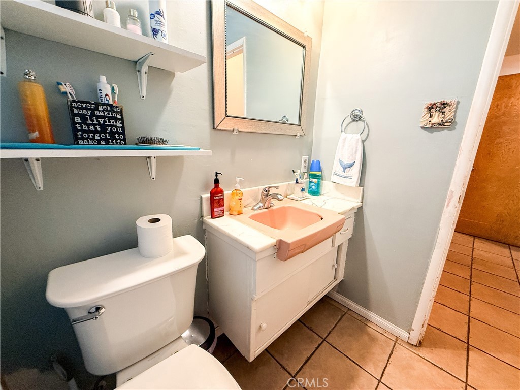 6712 La Jolla Drive Riverside, CA 92504 - Photo 14 of 29 a bathroom with a sink a toilet and vanity