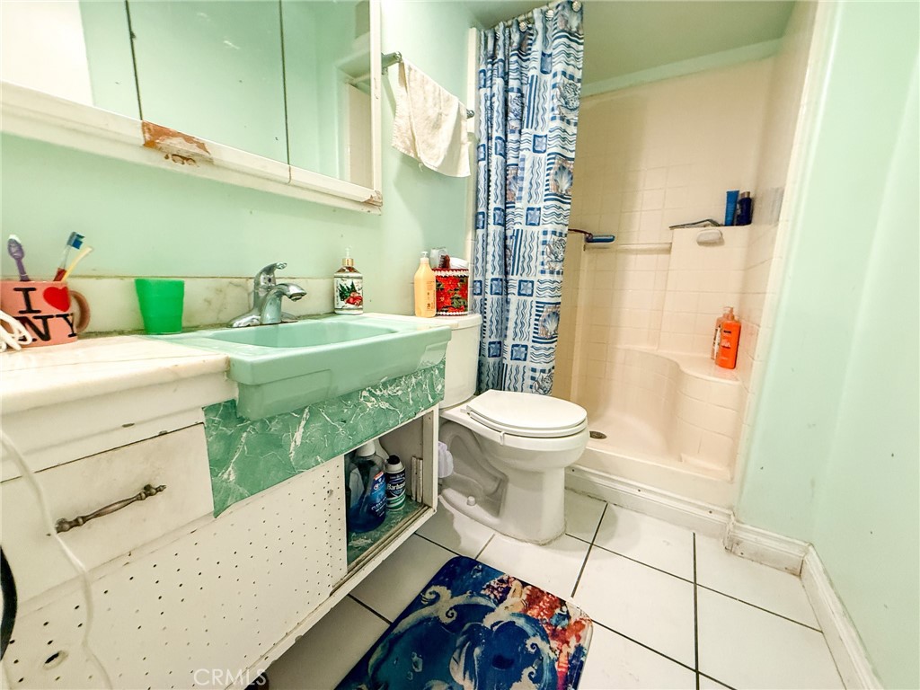 6712 La Jolla Drive Riverside, CA 92504 - Photo 17 of 29 a bathroom with a sink toilet and shower