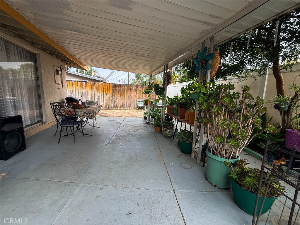 6712 La Jolla Drive Riverside, CA 92504 - Photo 24 of 29 a view of a patio with table and chairs potted plants and floor to ceiling window