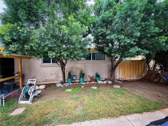 a backyard of a house with yard and trampoline