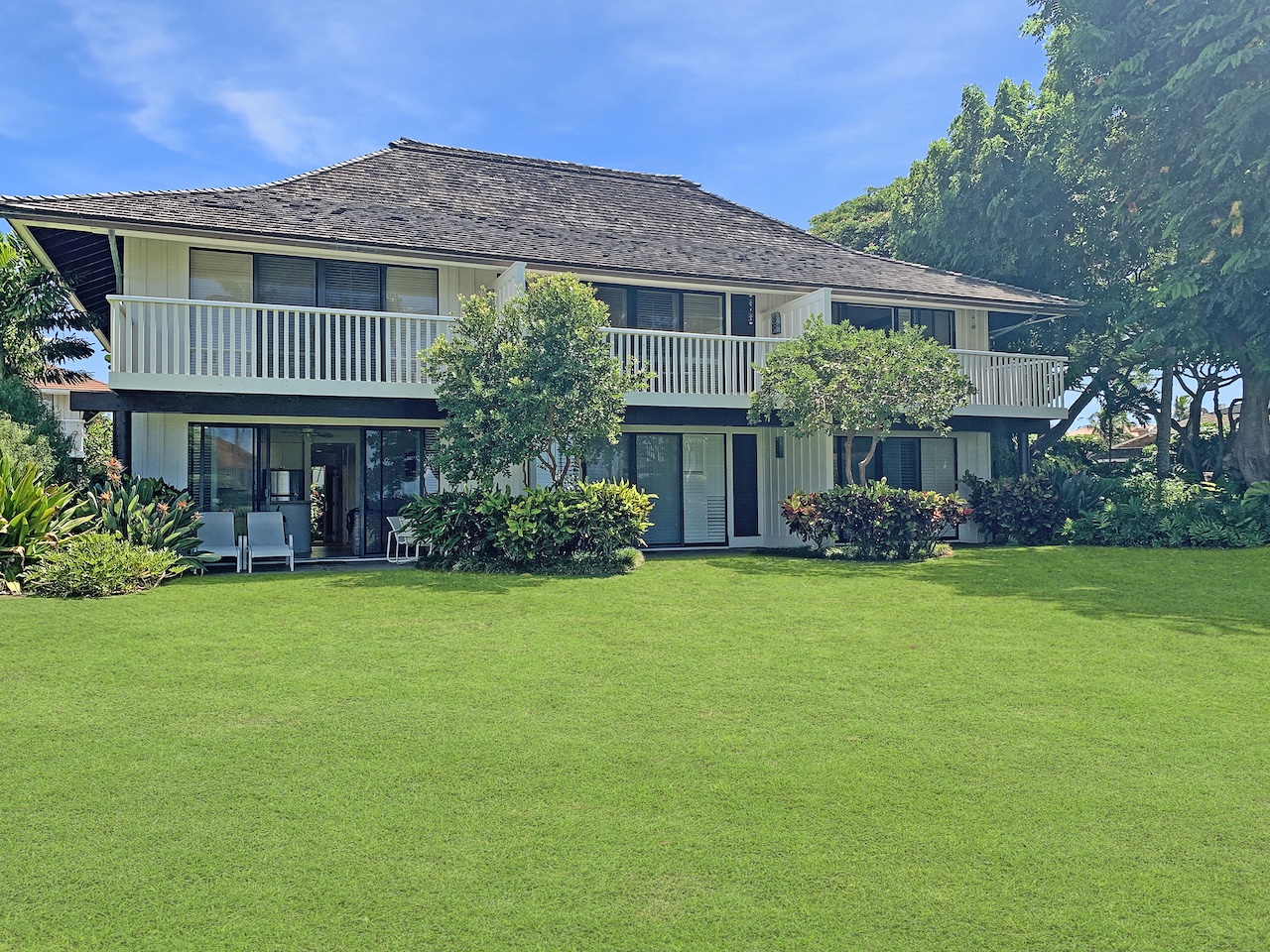 2253 Poipu Road, Unit 28 Koloa, HI 96756 - Photo 17 of 26 a front view of a house with a garden