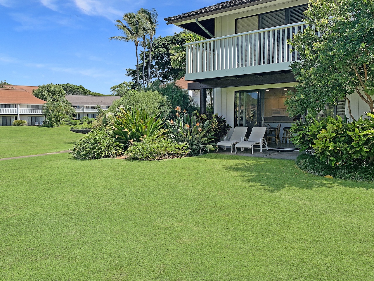 2253 Poipu Road, Unit 28 Koloa, HI 96756 - Photo 18 of 26 a view of a house with a yard and sitting area