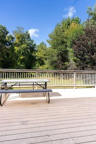 a view of a yard with wooden fence
