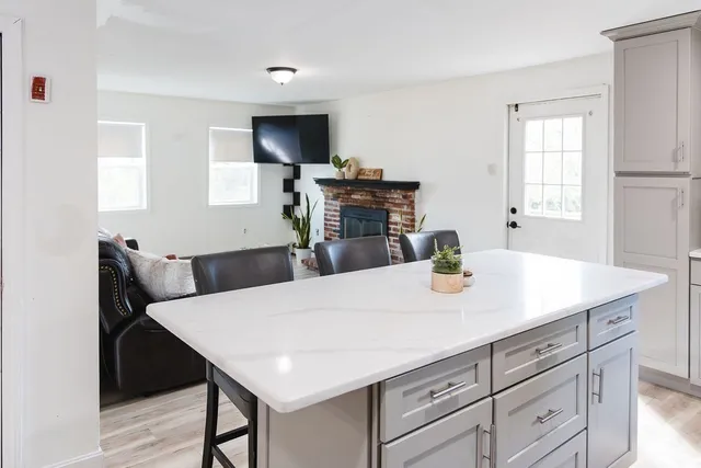 a kitchen with a table chairs and a refrigerator