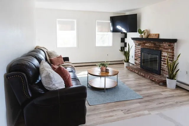 a living room with furniture and a fireplace