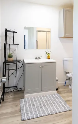 a bedroom with a bed a desk and mirror