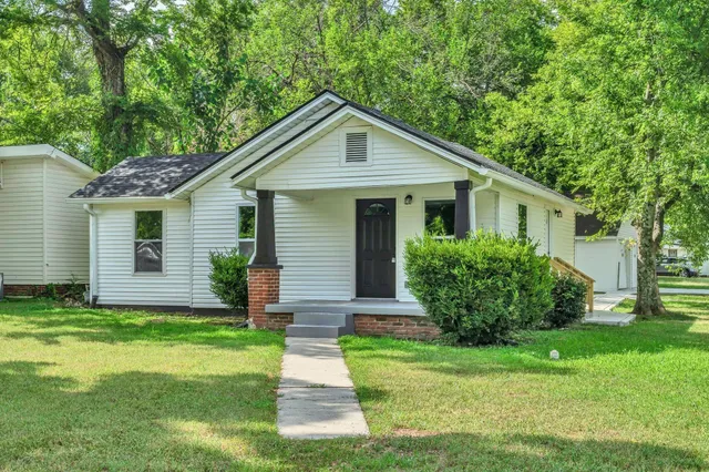 a front view of house with yard and green space