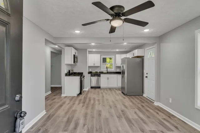 a kitchen with stainless steel appliances kitchen island a refrigerator and a stove top oven