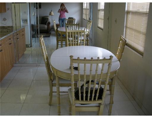 4002 Hythe A, Unit 4002 Boca Raton, FL 33434 - Photo 6 of 10 a view of a dining room with furniture