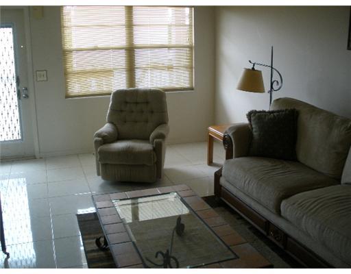4002 Hythe A, Unit 4002 Boca Raton, FL 33434 - Photo 7 of 10 a living room with furniture and a window