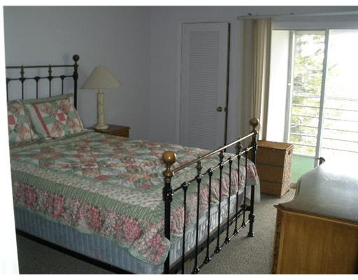4002 Hythe A, Unit 4002 Boca Raton, FL 33434 - Photo 8 of 10 a bedroom with a bed and a window