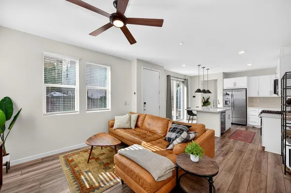 a kitchen with stainless steel appliances a stove a sink a microwave a refrigerator and cabinets